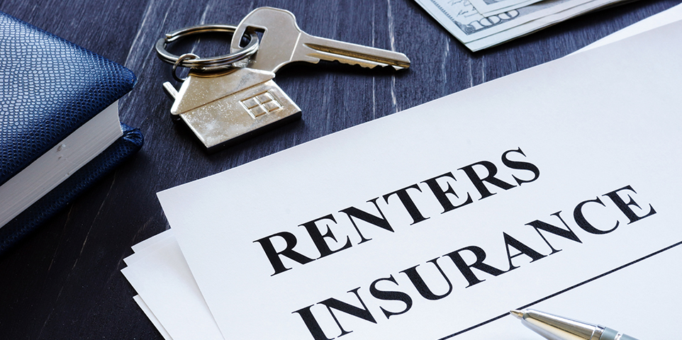 Renters Insurance policy agreement and key from apartments.